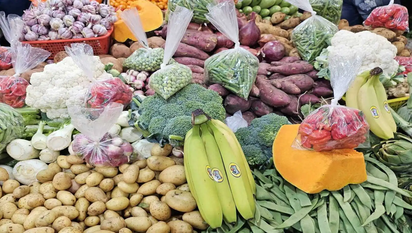 various vegetables on a table at an outdoor market